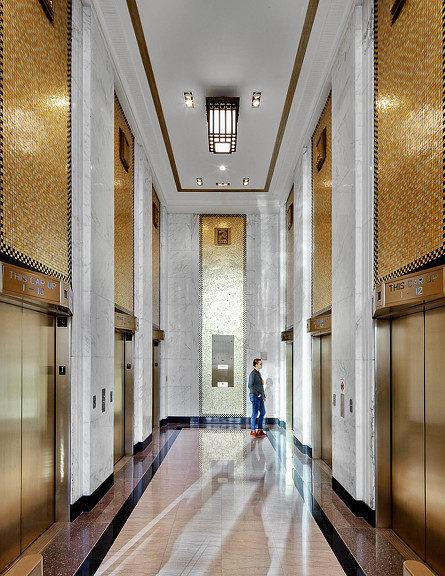 A person walking down a long hallway.